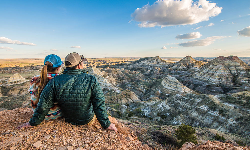 couple sitting mountain lookout Southeast Montana Travel