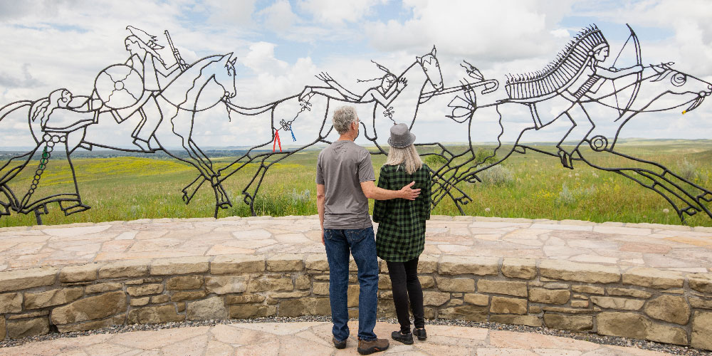 image of art in southeast montana with two people standing in front of it