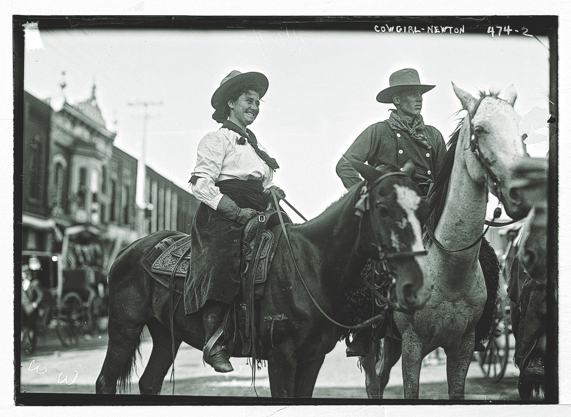 A Black Horse and a Cowboy with Blue Pants, Yellow Shirt and Big White Hat  — Two Graces, Art Books and Curios, Taos, NM